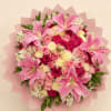 Pink lily and rose bouquet wrapped in pale pink paper