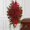 This rich, radiant spray of red roses, gladioli and other popular red