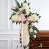 A beautiful cross with a swag of light pink roses with baby