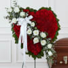 Heart-shaped red floral funeral spray with white roses and ribbon