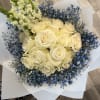 Bouquet of cream roses with blue baby's breath and white snapdragons