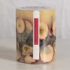Spicy apple candle in a clear glass jar with dried fruit slices