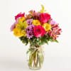 This seasonal spring arrangement features a bright and cheerful mix of blooms