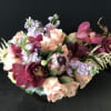 Bouquet of peach roses, burgundy orchids, and lavender flowers