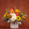 Mixed autumn bouquet in a white vase with sunflowers, roses, and hydrangea