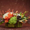 Capture the warm glow of autumn with this rich, amber-toned arrangement. Featuring