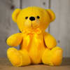 Yellow teddy bear with a satin bow