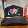 A playful twist on a gift-ready accessory, this Love trucker hat is