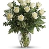 White roses arranged in a clear glass vase