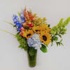 Colorful bouquet with sunflowers, hydrangea, and snapdragons in a glass vase