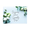 White roses and eucalyptus frame a sympathy vase sign
