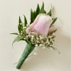 Pink calla lily boutonniere with baby's breath and greenery