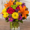 Vivid orange lilies take center stage in this bright everyday bouquet, making