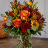 A rich, autumnal display of color greets the eye-this flower arrangement brings