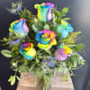 A burst of color and joy, this tie‑dye rose arrangement features swirling