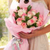 A charming and elegant bouquet featuring 12 beautiful pink roses gracefully accented