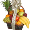 Fruit basket with bananas, grapes, oranges, and a pineapple in a wicker basket