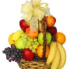 Fruit basket with apples, grapes, bananas, and oranges tied with a gold bow