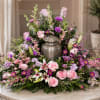 A soft, elongated spray that speaks of tenderness and remembrance, this cremation