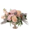 Pink and cream floral arrangement in a silver pedestal vase