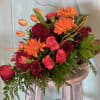 Bouquet of orange gerbera daisies, red roses, and pink carnations
