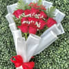Vivid red roses take center stage in this Congrats Grad bouquet, making