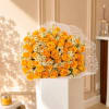 Bouquet of yellow roses and small white daisies in white wrap
