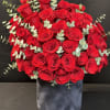 Large bouquet of red roses in a dark velvet box