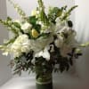 White lilies and tulips arranged in a glass vase