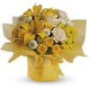 Yellow and white bouquet with lilies, roses, and daisies arranged in a yellow-wrapped square box.