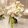 Bridal bouquet with roses, calla lilies, orchids, and hanging amaranthus. 