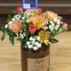A 16 oz candle with a lid filled with fresh, bright flowers.
*Colors