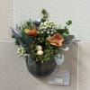 A wild flower style artificial arrangement with an artificial birds nest in