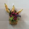 A basket wall hanger filled with artificial blooms. 