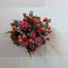 Wall-mounted floral arrangement with pink blooms and orange buds