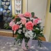 Pink roses and carnations in a pale pink vase