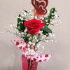Tall pink vase with two red roses, baby’s breath, and a glitter heart pick