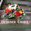 Colorful mixed flower bouquet with a designer choice sign