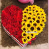 Heart-shaped box filled with red roses and yellow sunflowers