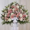 Large pink and white floral spray with a white ribbon bow