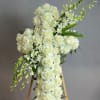 White rose cross on a wooden stand with trailing white flowers
