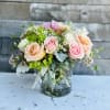 Bouquet of pastel roses in a clear glass vase