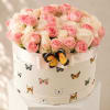 Pink and white roses in a round hat box with butterfly decorations