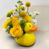 Yellow rose and chrysanthemum arrangement in a duck-shaped ceramic container