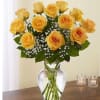 Yellow roses arranged in a clear glass vase with baby's breath