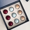 Box of assorted round chocolates in red, blue, and gold