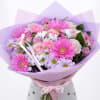 Pink and lavender bouquet with gerbera daisies, roses, and daisies wrapped in purple paper