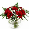 A charming vase arrangement featuring vibrant red roses, delicate baby&rsquo;s breath, and
