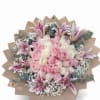 Round bouquet of pink and white roses with pink lilies and baby's breath wrapped in tan paper.