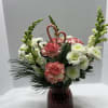 Red vase filled with mixed pine and flowers 